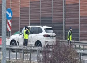 policjantki stoją przy zatrzymanym pojeździe