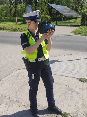 policjantka trzyma urządzenie do pomiaru prędkości