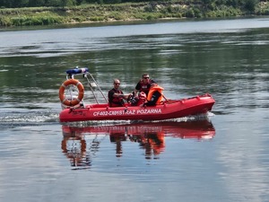 policjant i strażacy na akwenie wodnym