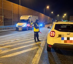 policjant stoi przy samochodzie na autostardzie